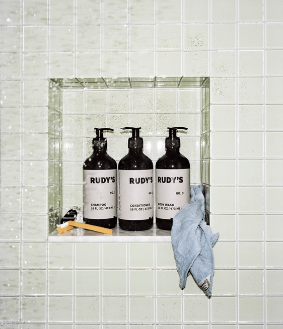 Rudy's hair care products in a shower. 