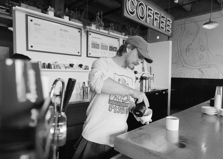 A barista makes coffee at Water Ave.