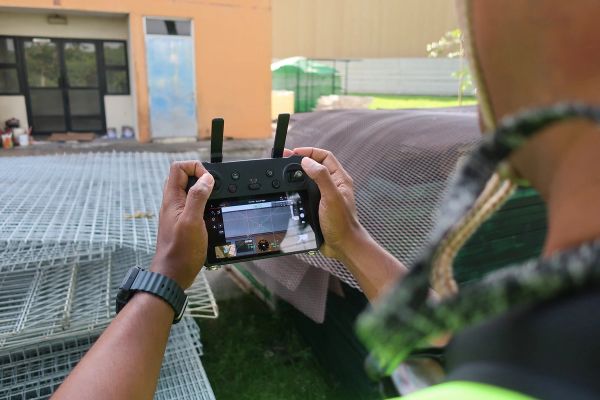 Close-up of a drone operator viewing the controller screen