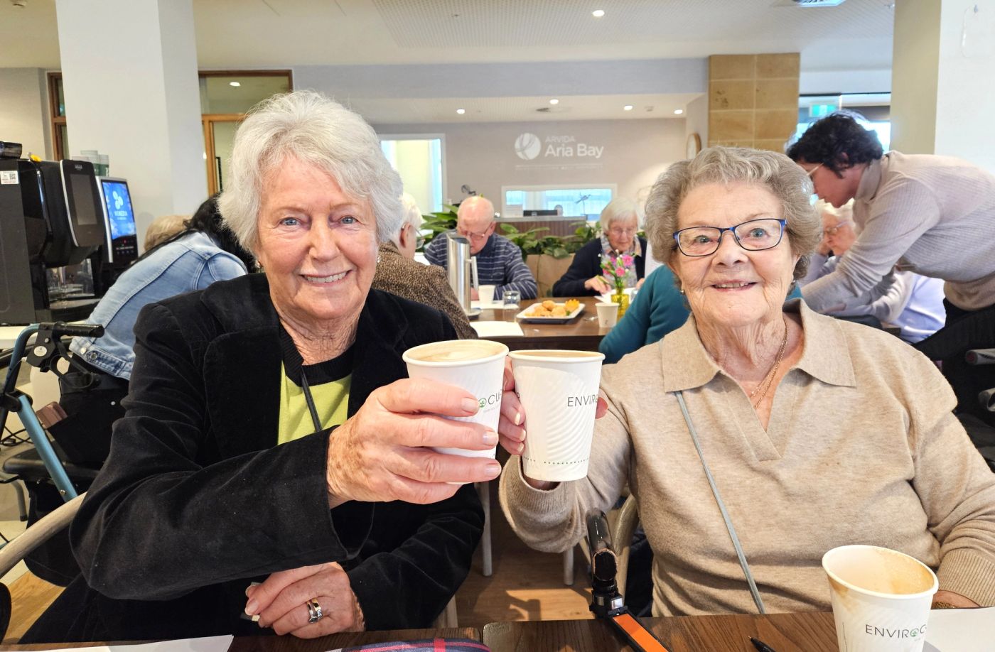 Two female residents having coffee in a retirement village