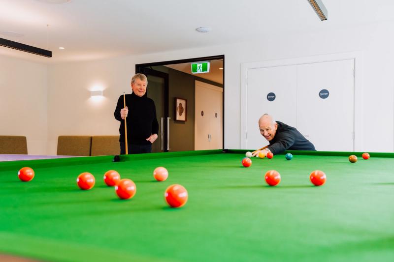 Two residents playing snooker