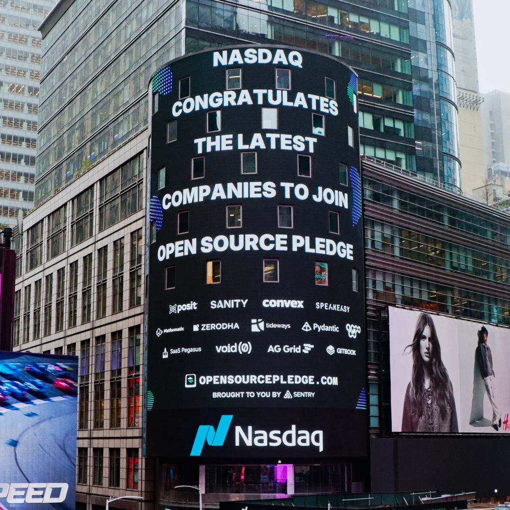 The big Nasdaq screen in Times Square, bearing the message “Nasdaq congratulates the latest companies to join the Open Source Pledge”, followed by some member company logos, and the URL https://opensourcepledge.com