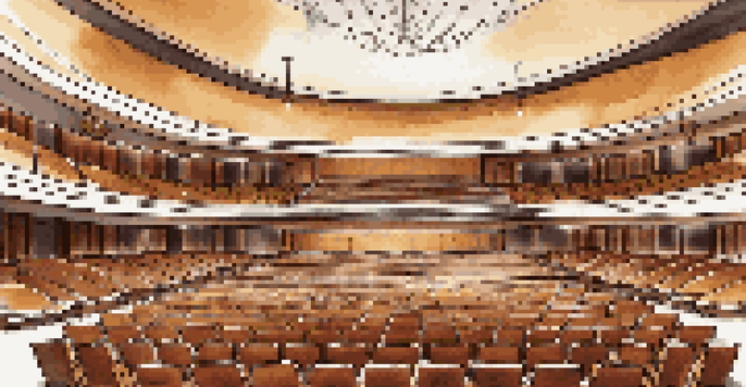 An elegant concert hall interior with a fan-shaped layout, plush seating, wooden acoustic panels, and a well-lit stage area with musical instruments.