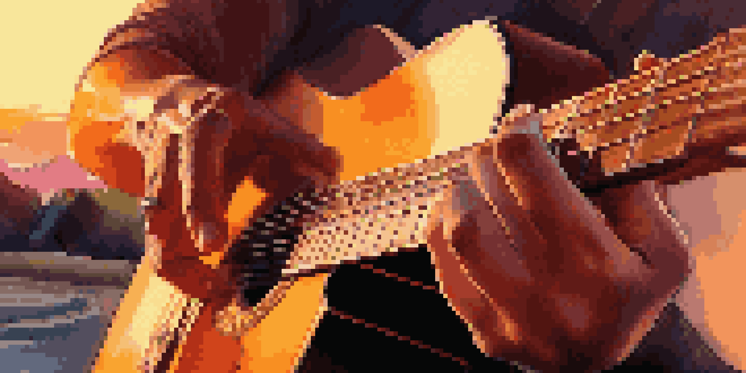A musician's hands playing a guitar against a colorful sunset background.