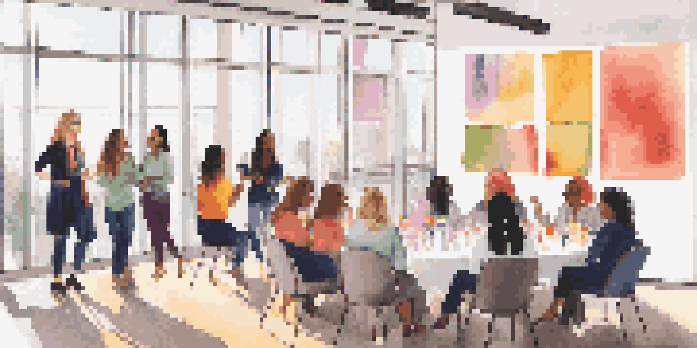 A lively networking event with diverse women engaged in discussions about music licensing, surrounded by colorful banners and natural light.