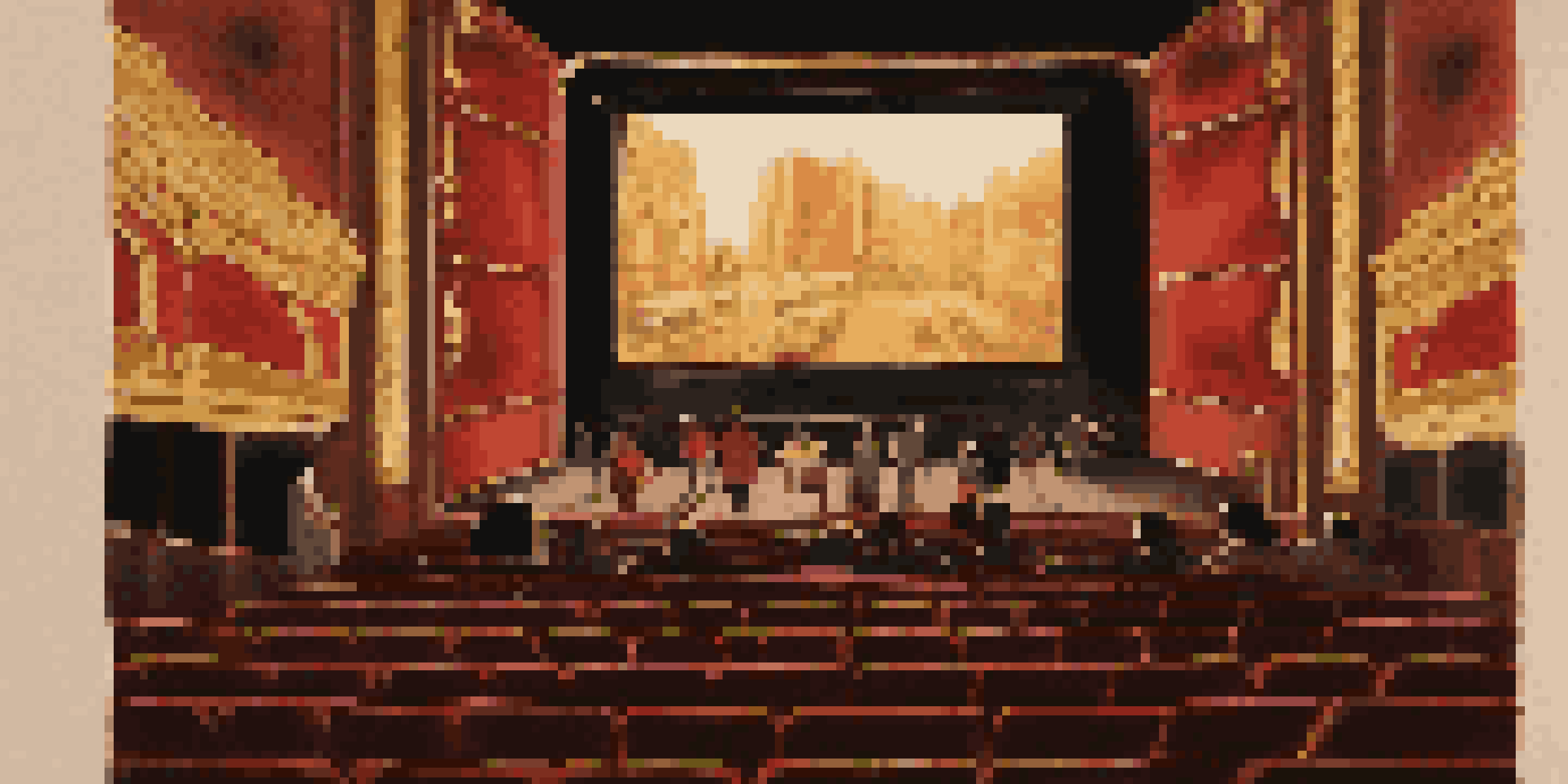 A vintage cinema with an audience watching a classic black and white movie, surrounded by warm golden and red hues.