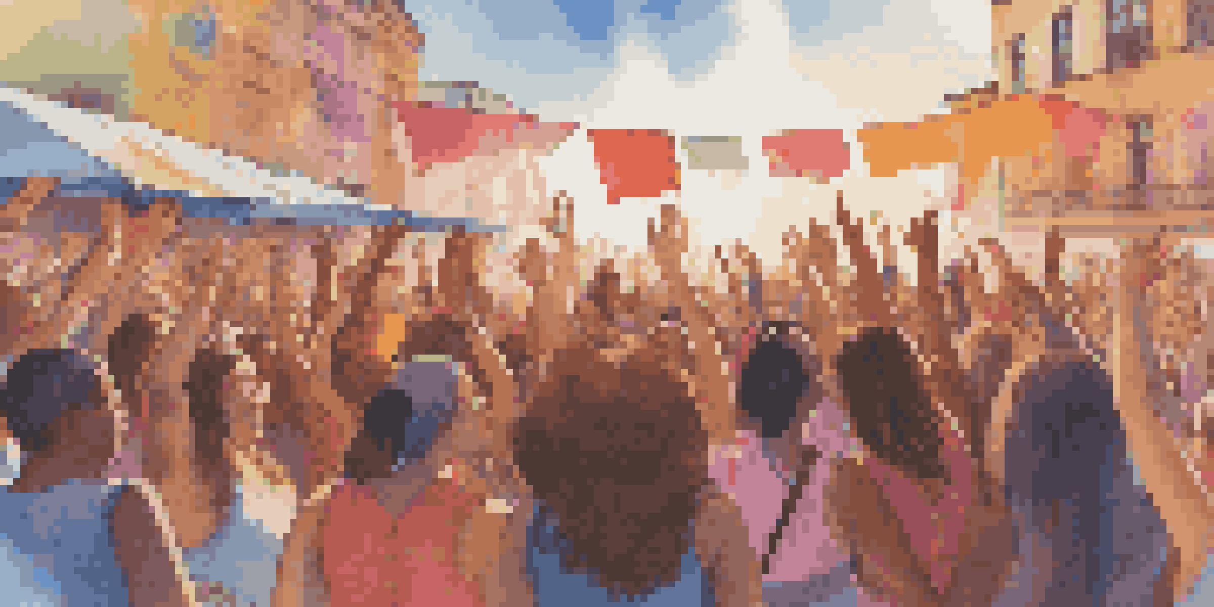 A lively music festival with women artists on stage, colorful banners, and a cheering crowd under warm sunlight.