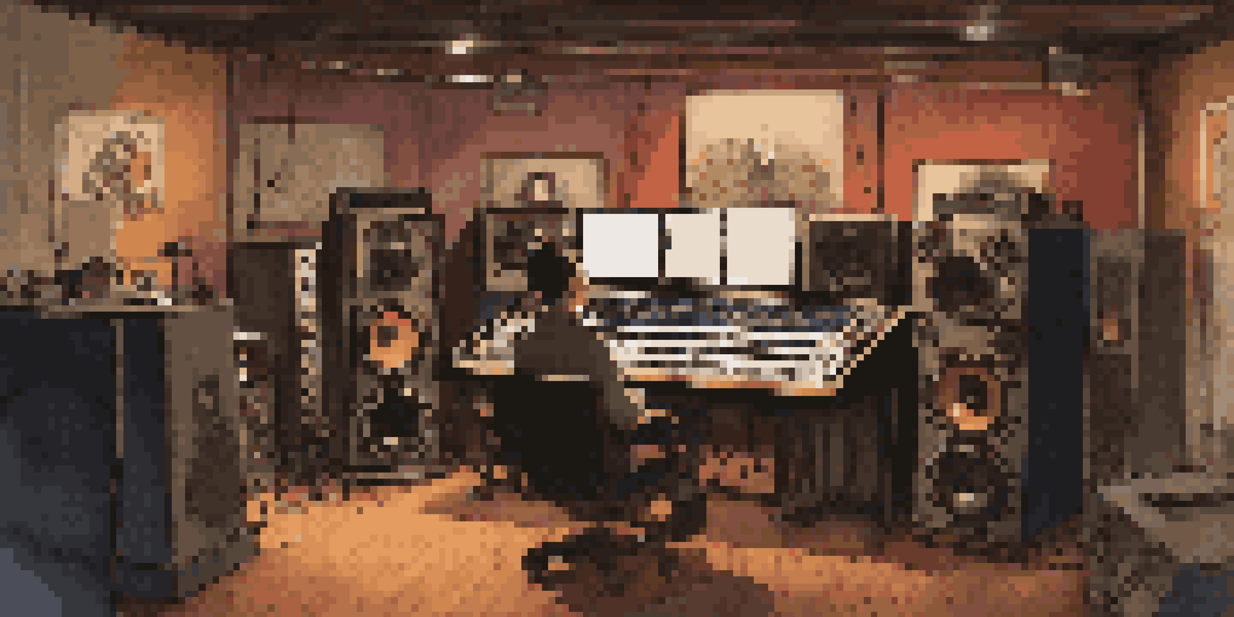 A sound designer working in a warm, cozy film studio surrounded by sound equipment and film posters.