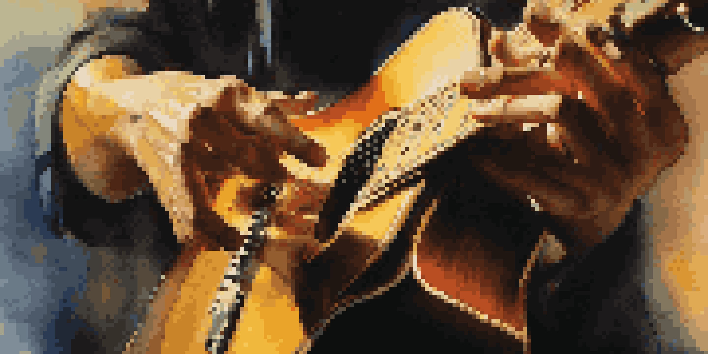 A close-up of a musician's hands playing a guitar on stage with an audience in the background.