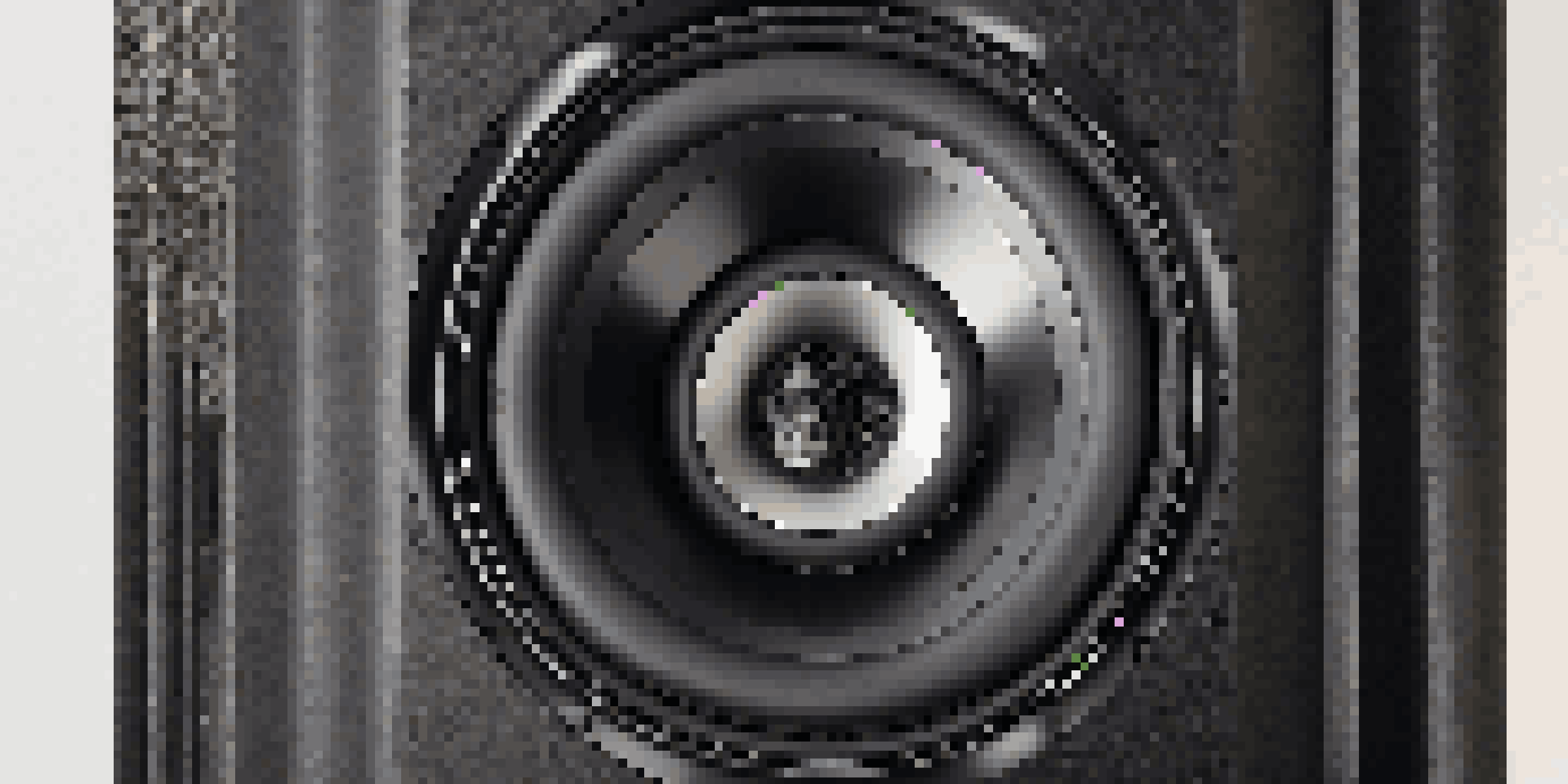 Close-up of a black matte subwoofer with a detailed speaker cone and enclosure, highlighted by soft lighting.
