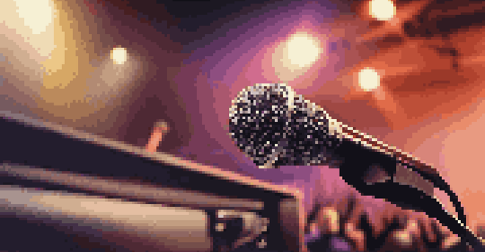 A professional audio setup with a microphone and speaker, positioned to minimize acoustic feedback, illuminated by warm lighting.