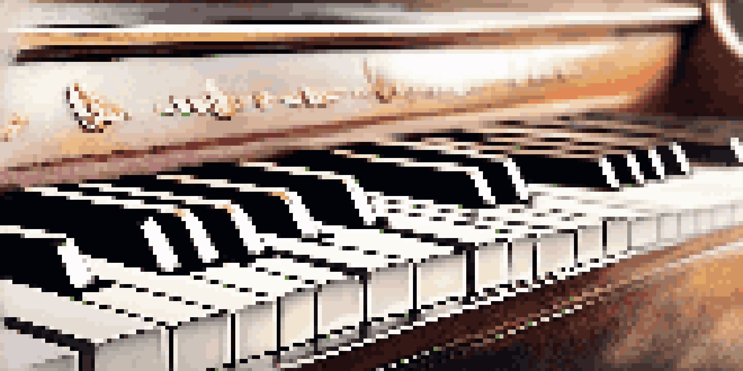 A close-up view of piano keys with fingers playing chords, softly lit with blurred sheet music in the background.