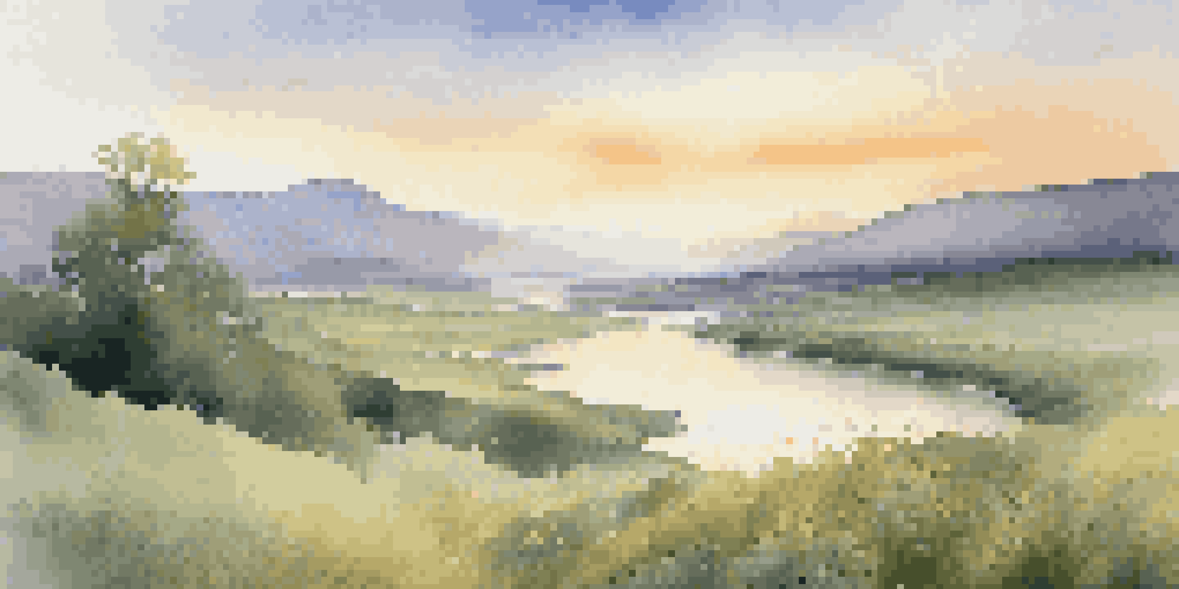 A peaceful valley at sunrise with a river and misty mountains in the background.