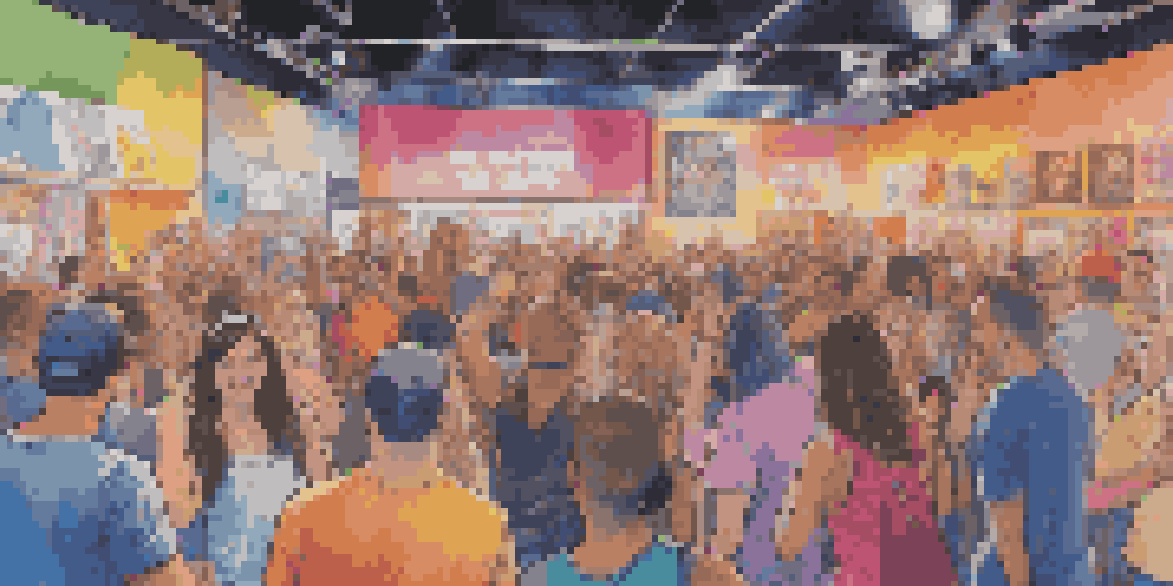 A lively concert scene where fans are customizing their own merchandise, with colorful items and a bright stage in the background.