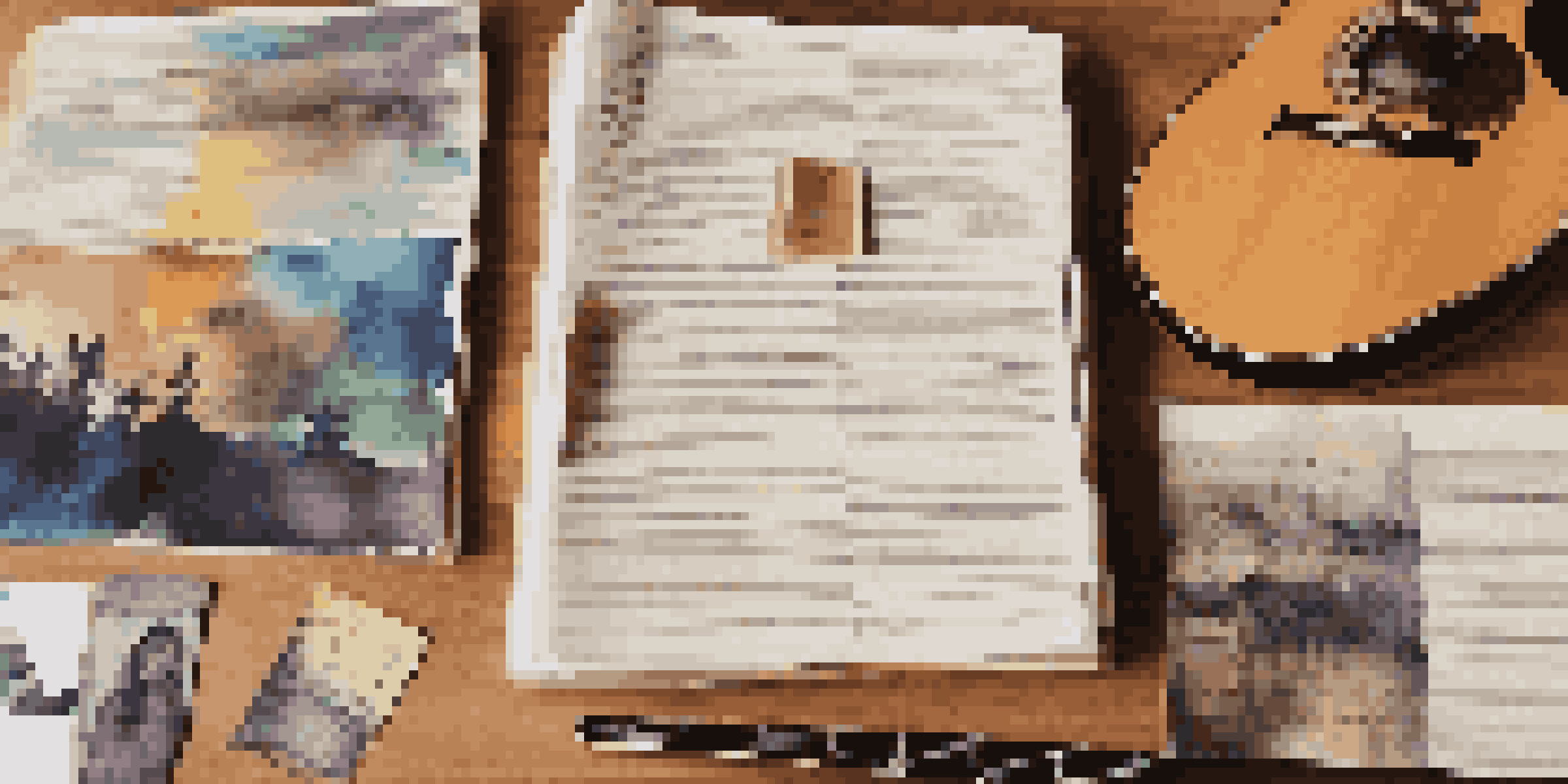 A songwriting portfolio displayed on a wooden desk with album covers and handwritten lyrics, illuminated by soft natural light.