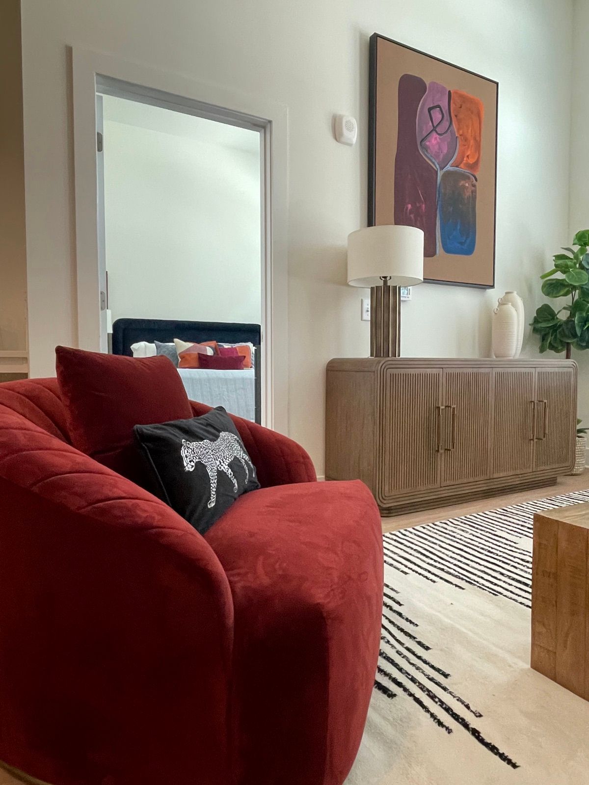 The Assembly, red velvet sofa with layered art