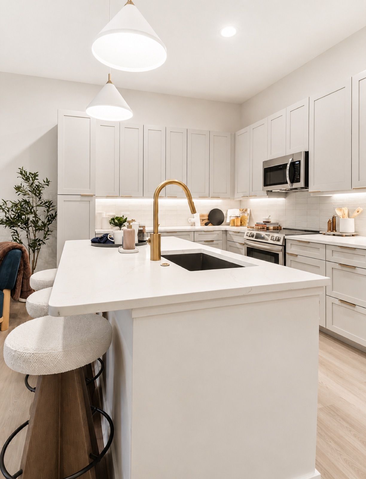 The Residence Peninsula, white kitchen with brass fixtures