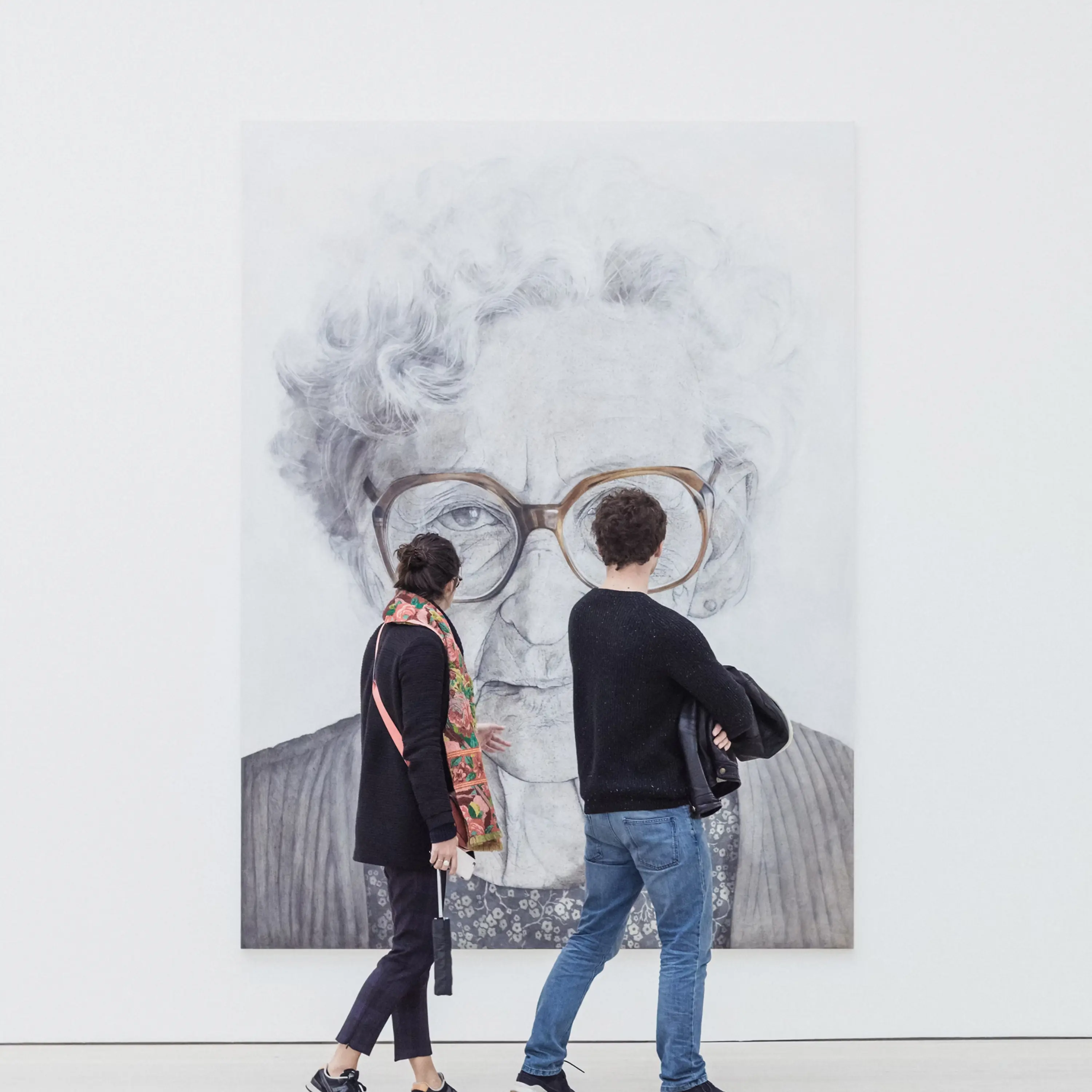Two people looking at an artwork.