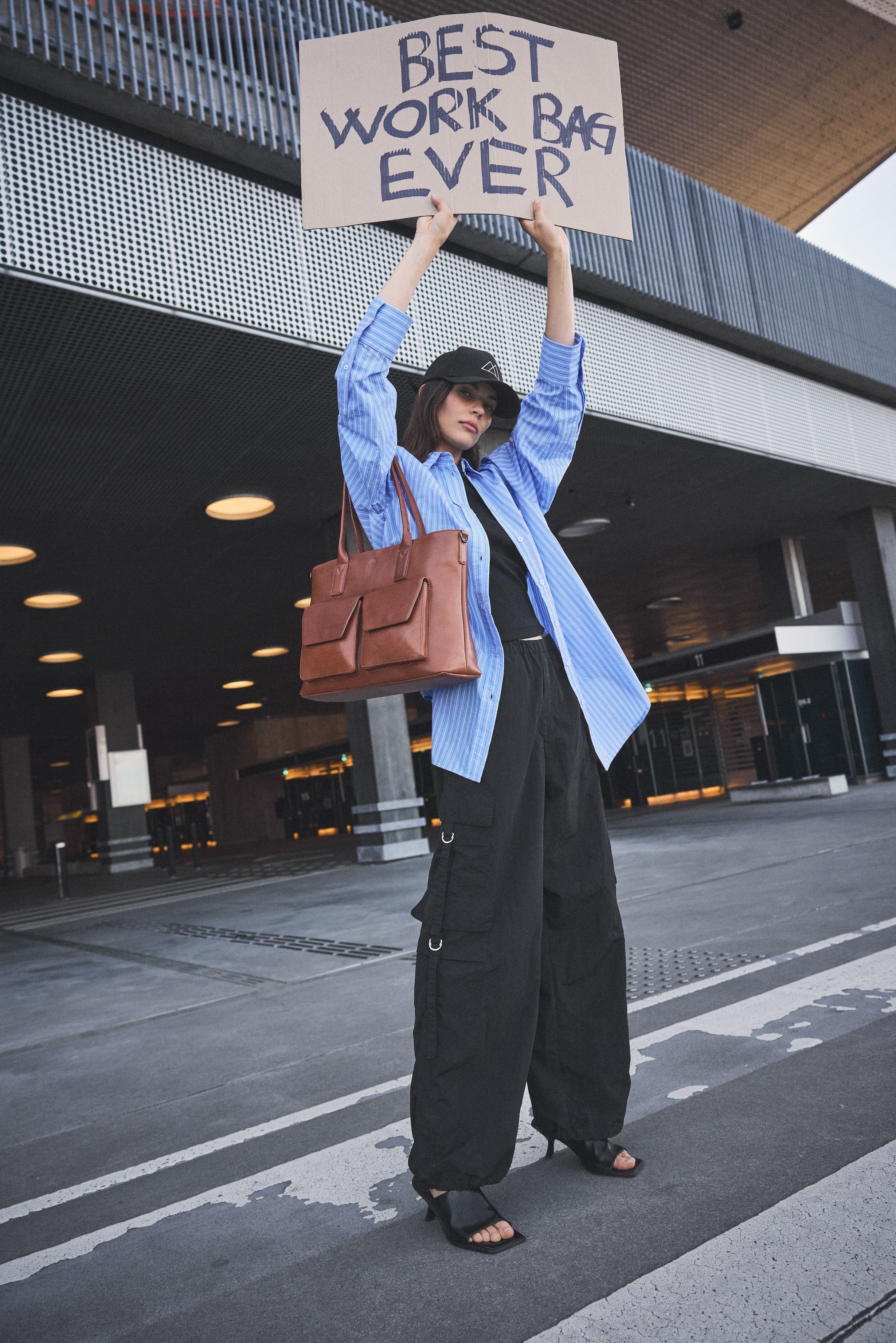 Markberg model with sign saying "best work bag ever"