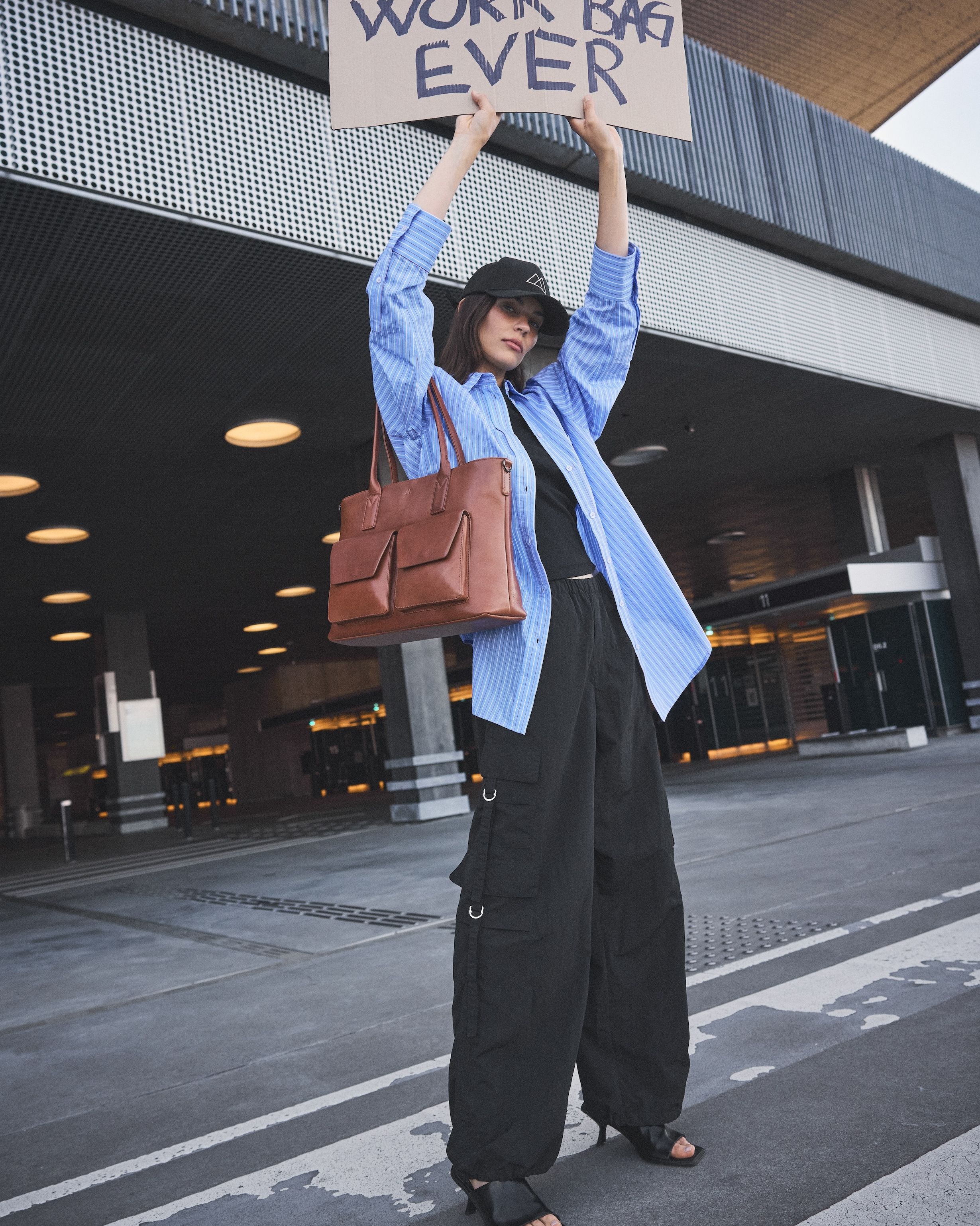 Markberg model with sign saying "best work bag ever"