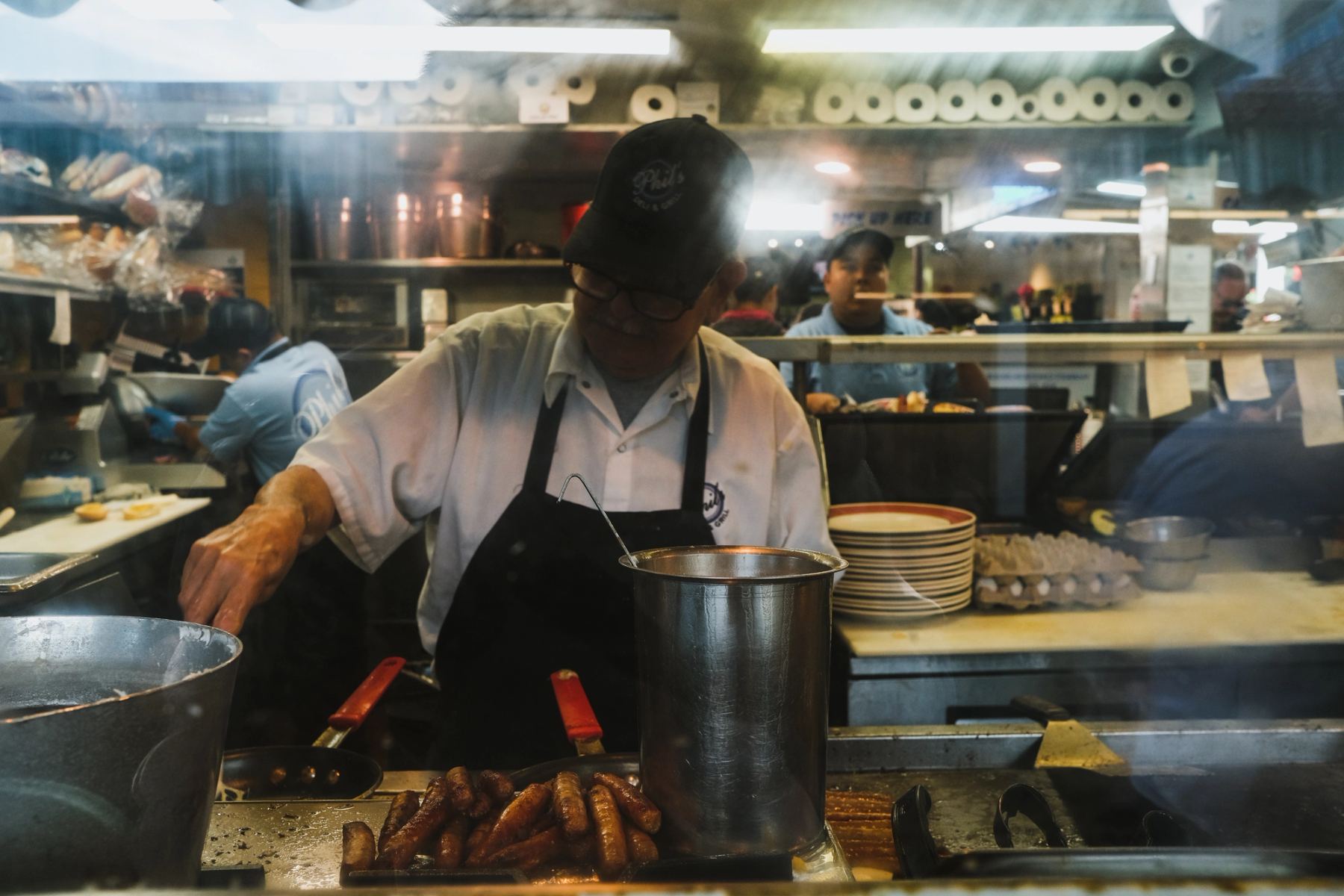 A man cooking sausages