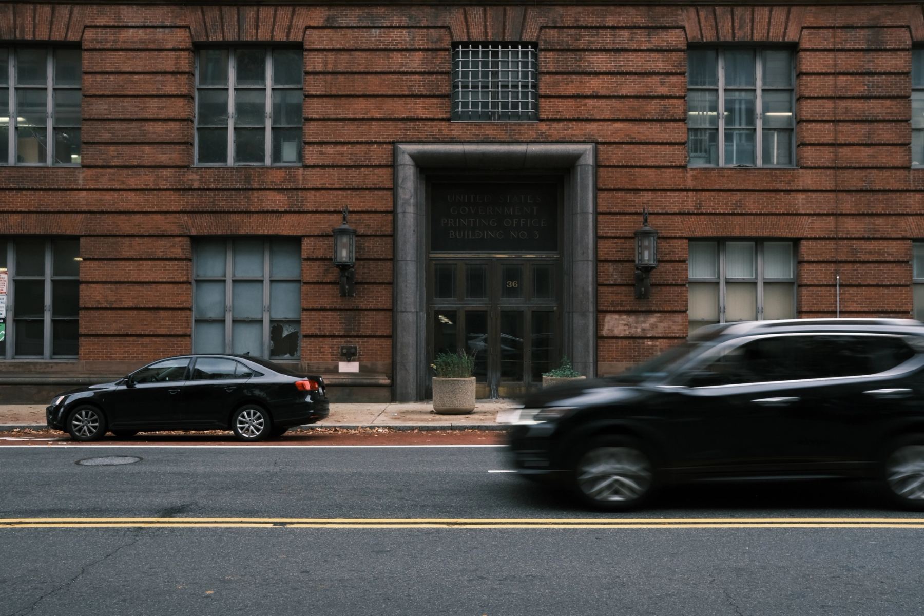 Two cars in front of a building