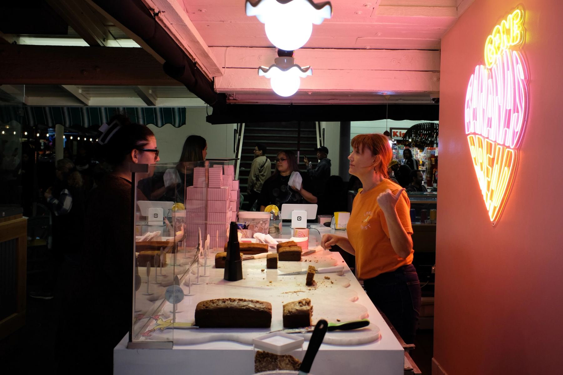 People talking at a cake shop