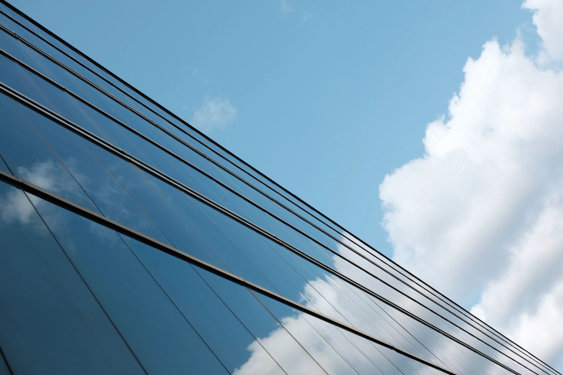 Glass wall reflecting sky