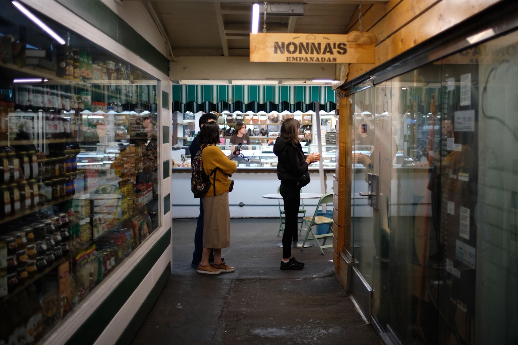 People standing in line in front of a shop