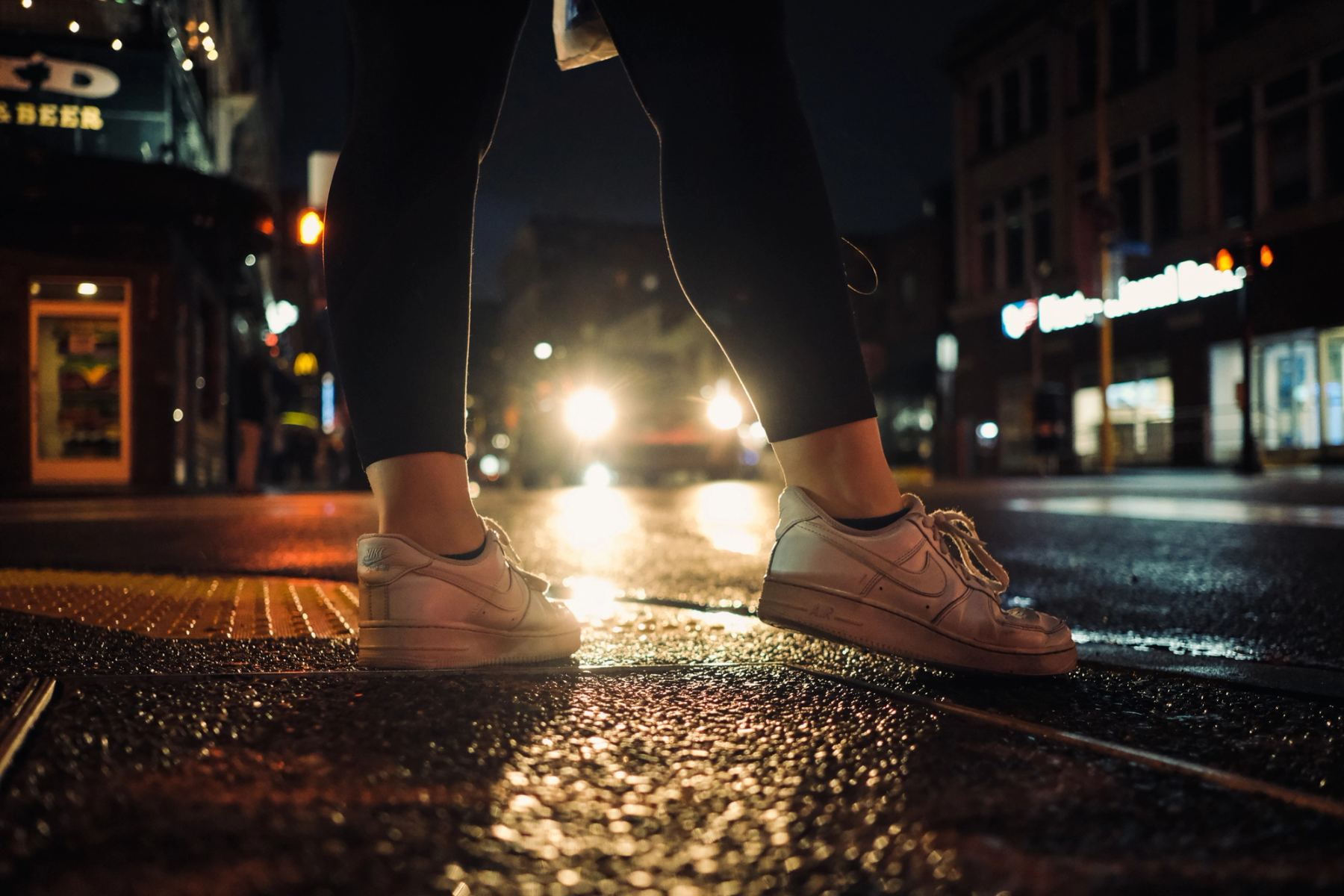 A person standing wearing white sneakers