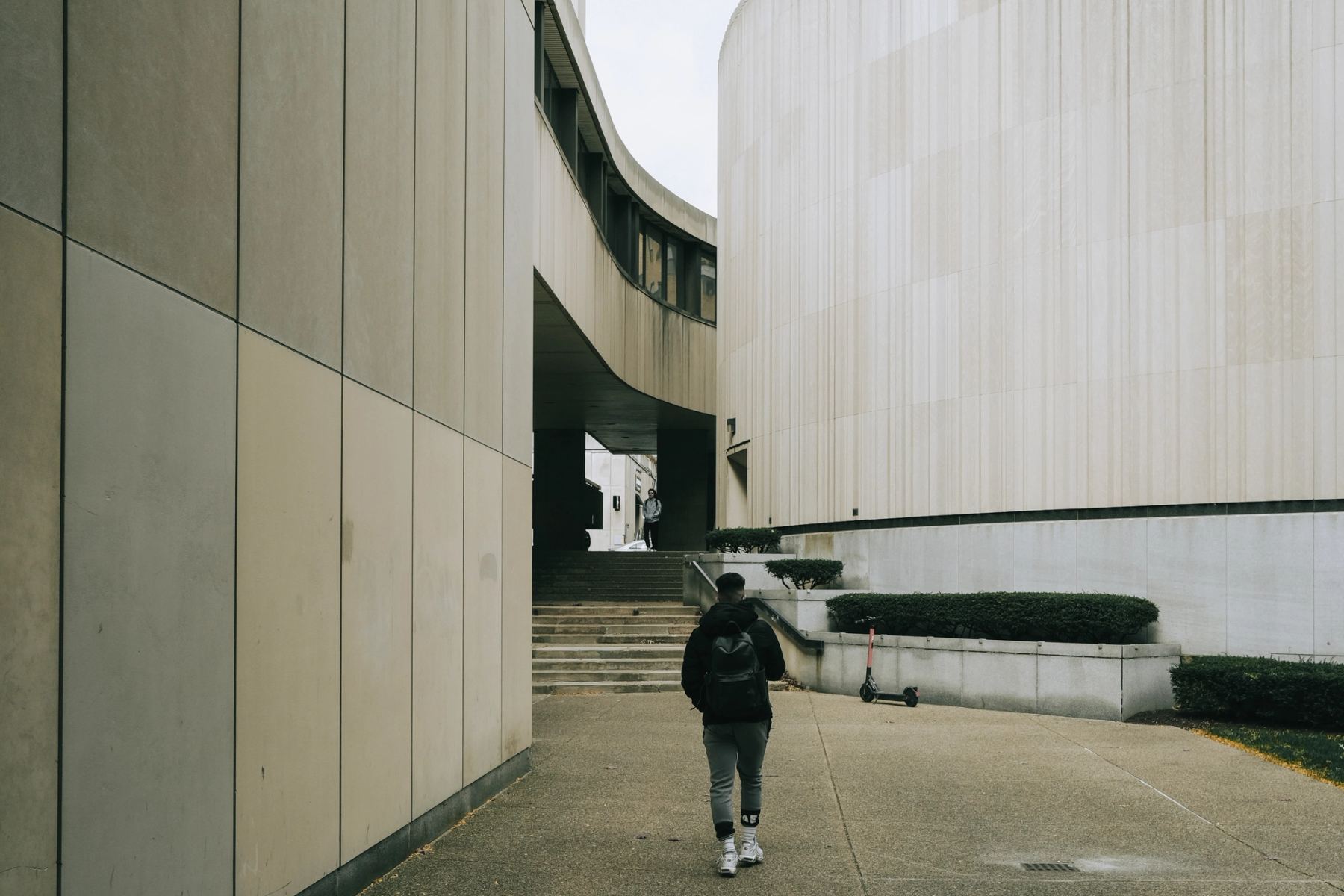 A man walking through building structures