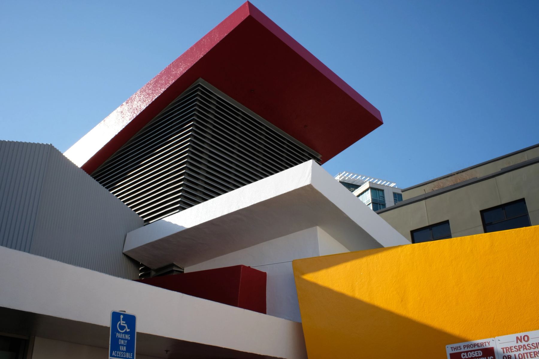 A building structure with white, red, and yellow paint on the walls