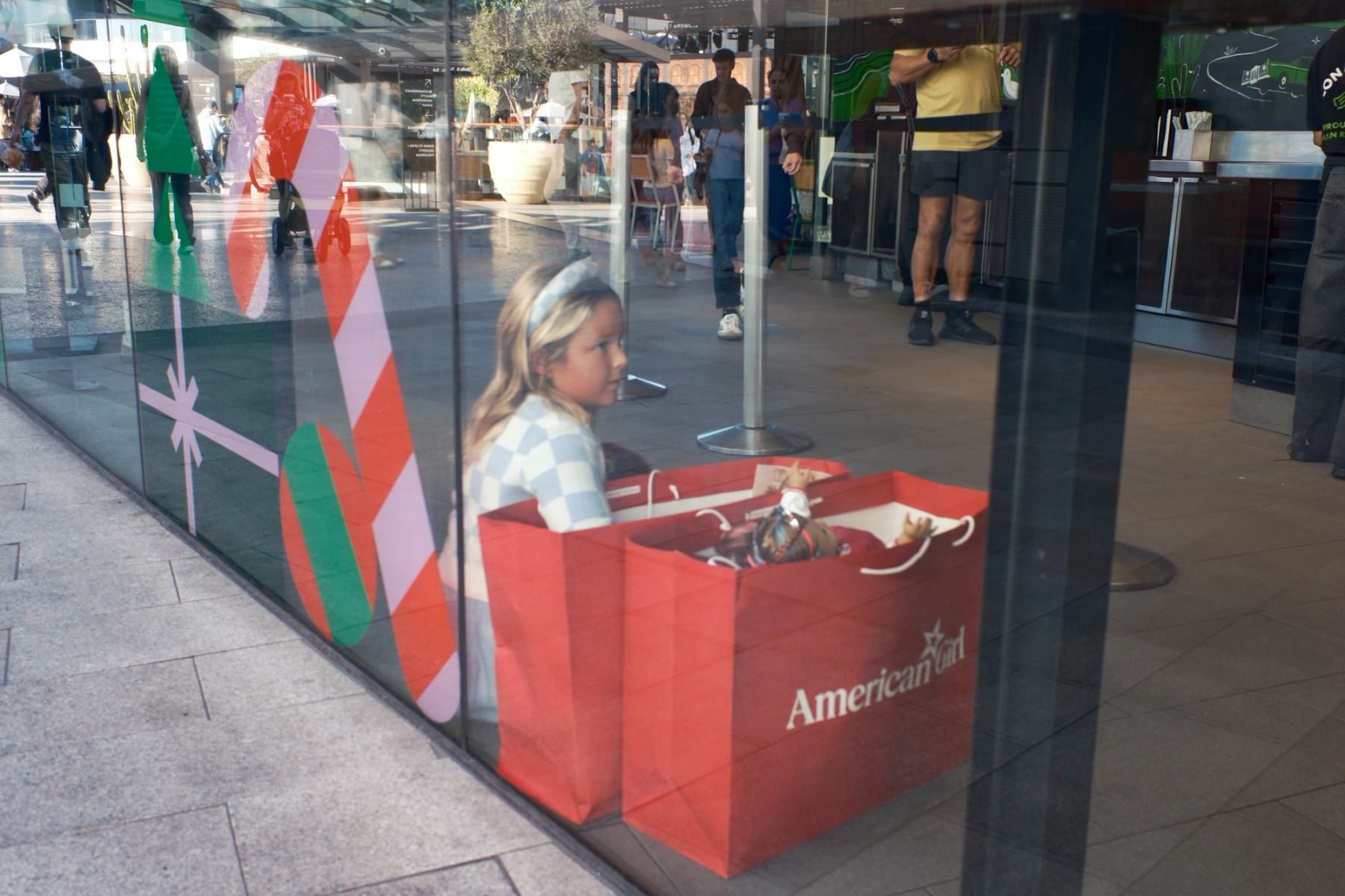 A girl sitting behind a window