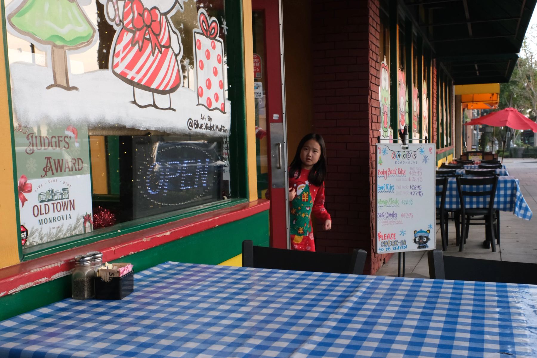 A girl walking out of a restaurant
