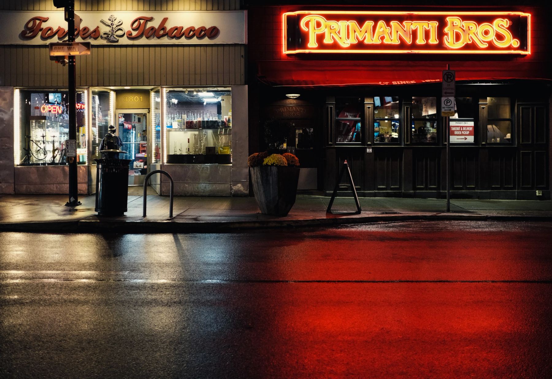 Neon light bouncing off wet ground after rain