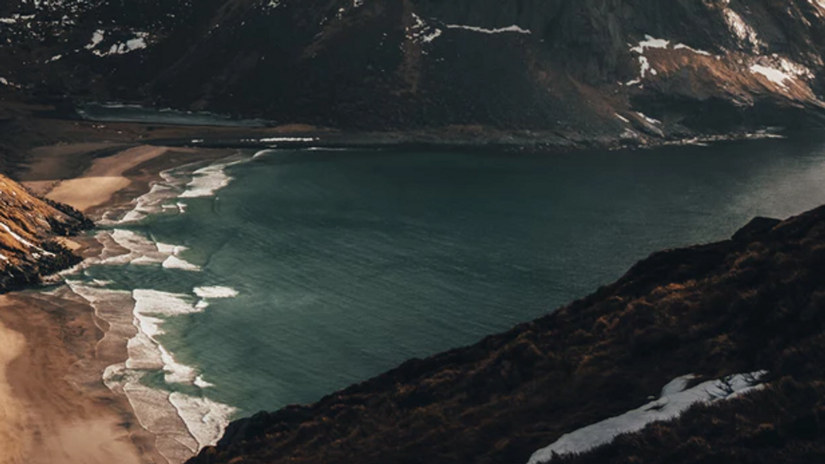 Mountains in cloudly weather with a beach.