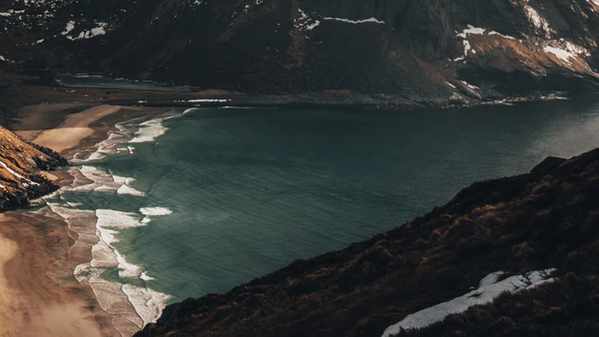 Mountains in cloudly weather with a beach.