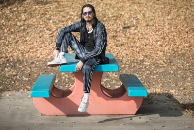 GUY SITTING ON TOP OF A BENCH