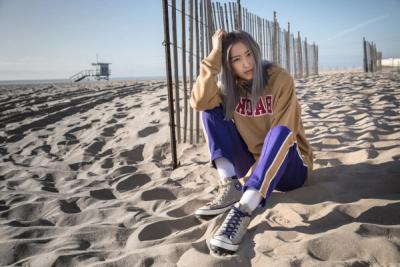 WOMAN SITTING ON THE BEACH