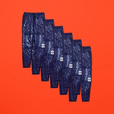 Diagonally repeated images of a navy nylon quilted pant. Converse x P.A.M. (Perks and Mini) collab. 