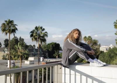 DUDE SITTING IN A GREY TRACKSUIT