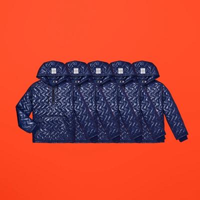 Horizontally repeated images of a navy quilted nylon pullover hoody. Converse x P.A.M. (Perks and Mini) collab. 
