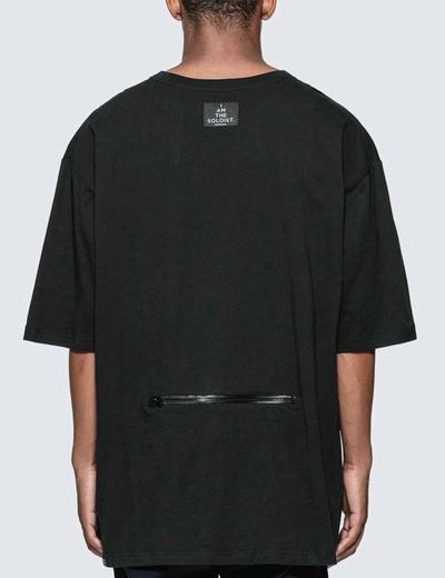 A man in a black tee w his back to the camera. Soloist x Converse collaboration.