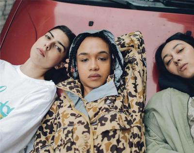 Three women laying on the hood of a car. Converse X Faith Connexion, Koché, Feng Chen Wang collaboration