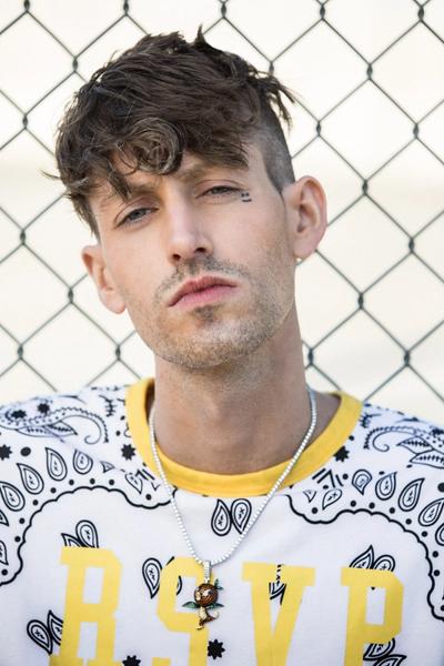 YOUNG MAN LOOKING INTENTLY INTO THE CAMERA