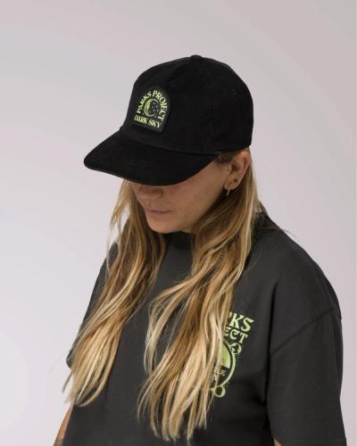 Woman modeling the Parks Project tee and the hat from the Dark Sky collection.