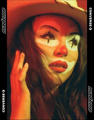 Portrait of Paloma Elsesser (beautiful latinx woman) wearing clown makeup and a cowboy hat. Featured brands: Converse & MadeMe
