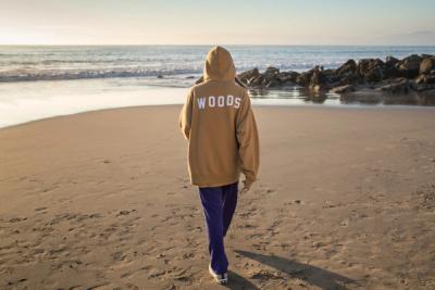 WOMAN ON THE BEACH WALKING AWAY