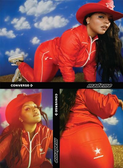 A collection of images of model Paloma Elsesser (beautiful latinx woman) wearing a 90s western style tracksuit and a cowboy hat. Featured brands: Converse & MadeMe90s style red & white western tracksuit against a fake backdrop of a blue sky with white clouds. Featured brands: Converse & MadeMe. 