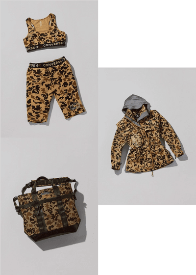 A collection of laydowns of 4 duck camo camouflage items. One utility tote, one parka w reflective, a body-con bike shorts and a sports bra. Converse X Faith Connexion, Koché, Feng Chen Wang collaboration